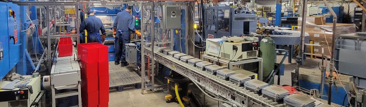 Employees work in the cell assembly line at Surrette Battery’s factory in Springhill, Nova Scotia